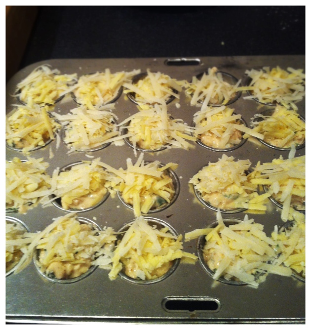 Filled muffin cups topped with cheeses